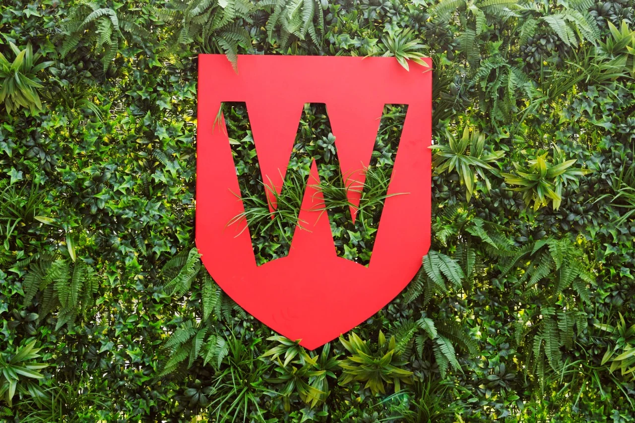 Western Sydney University shield on foliage background,Western Sydney University shield on foliage background