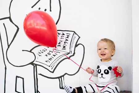 baby holding a balloon