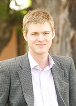 Dr Brett Bennett with trees in the background.