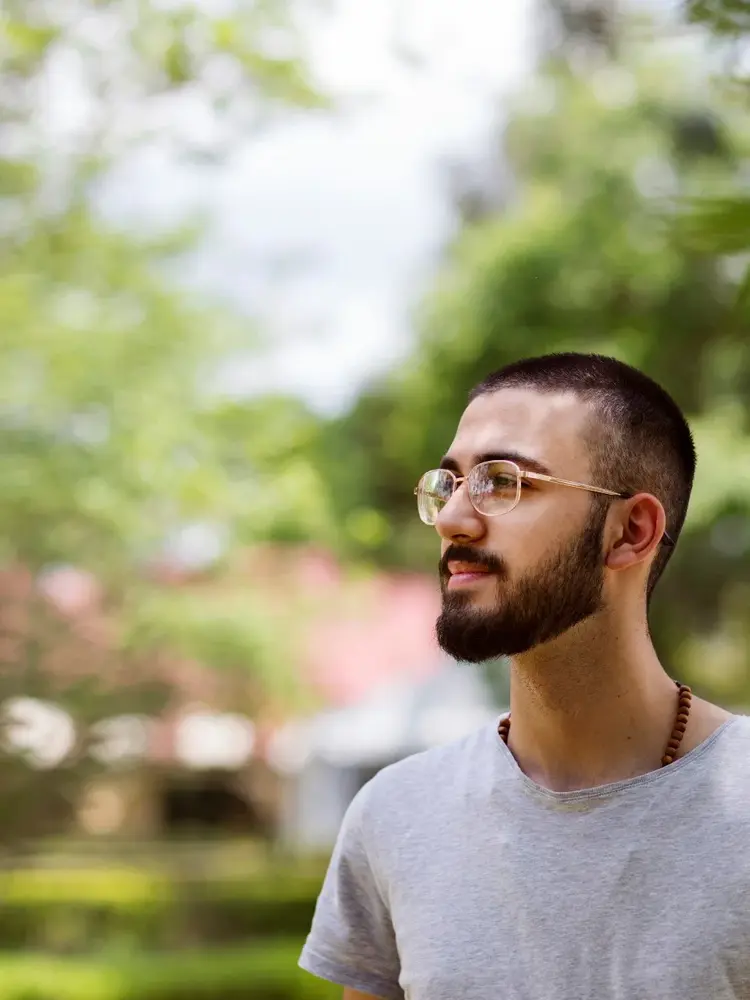 Male student and scholarship recipient standing outside