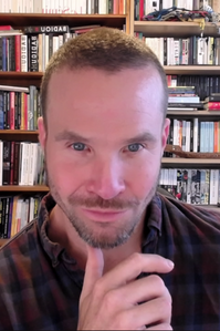 Alex smiles at the camera.