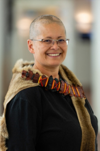 Madison wears a long-sleeved black top with a