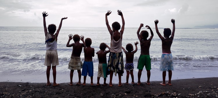 Ambrym,Vanuatu-October 10, 2014: Eleven kids playing on the beach while their parents work in the village shop on October 10, in Olal-Vanuatu.